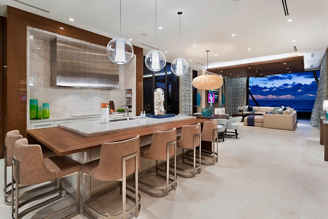 luxury kitchen island with hanging pendant lights and additional seating