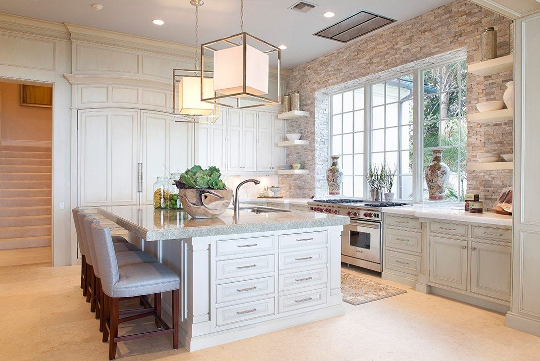 Brightly lit country-style kitchen with light fixtures above an island.